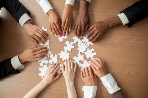 Business people assembling puzzle