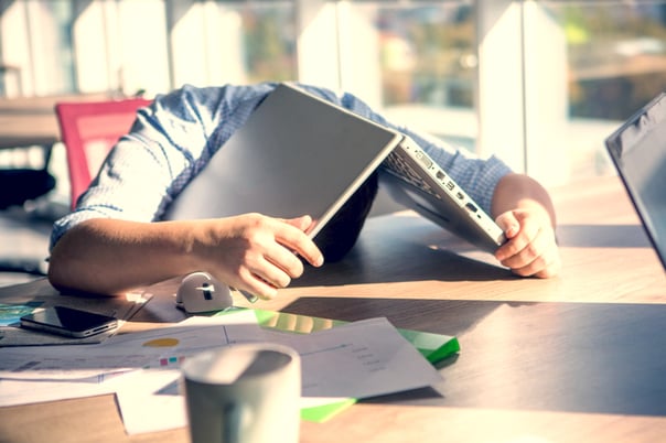 man with laptop over his head