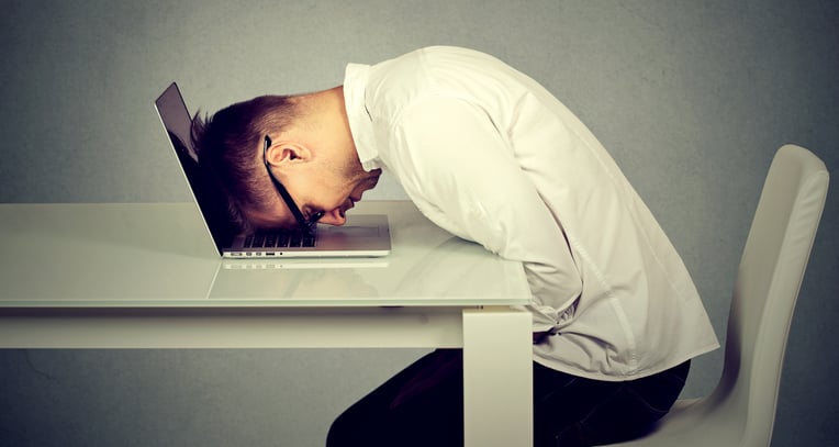 Man banging head on desk