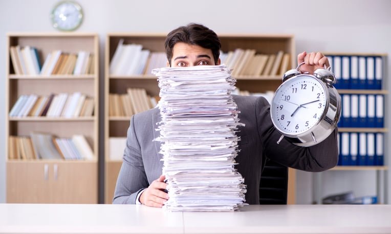 Man with Paper Pile shutterstock_557612260