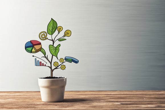 a plant with leaves that have business growth symbols on them