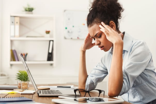 Stressed woman at her desk