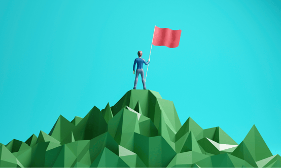 man with flag on a mountain