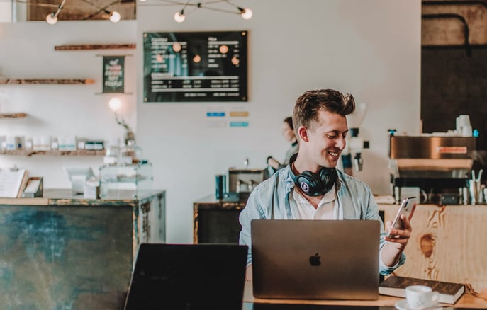 a worker working at a computer in a coffee shop